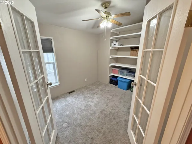 a view of a room that has a bed and a chandelier