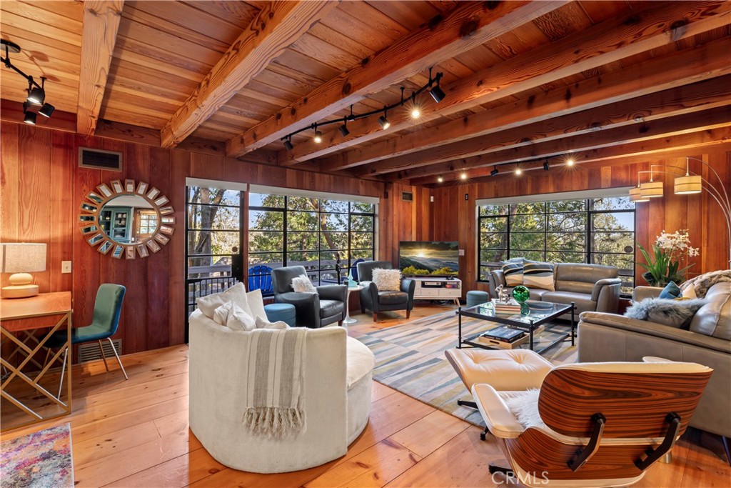 309 Castle Gate Road Lake Arrowhead, CA 92352 - Photo 11 of 58 a living room with furniture a wooden floor and a large window