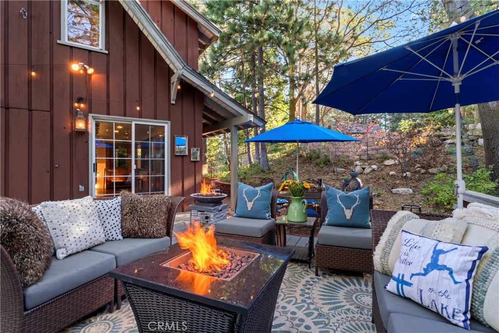 309 Castle Gate Road Lake Arrowhead, CA 92352 - Photo 2 of 58 a outdoor space with patio the couches and a umbrella