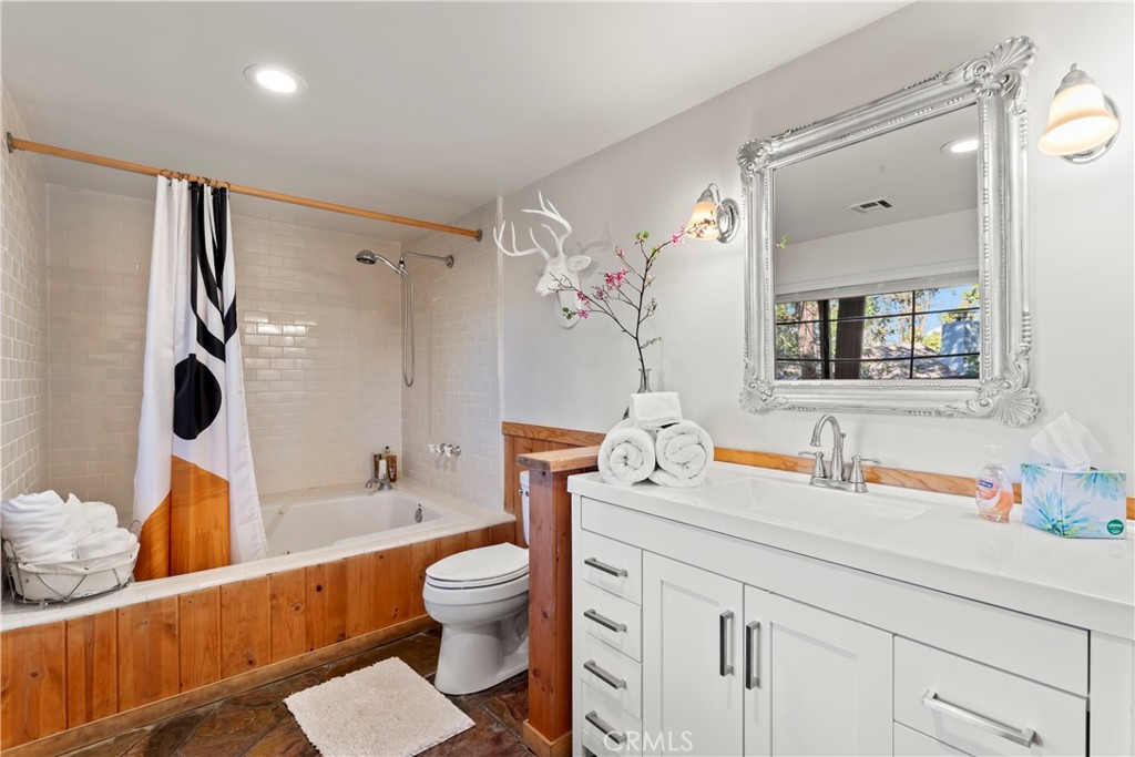 309 Castle Gate Road Lake Arrowhead, CA 92352 - Photo 42 of 58 a bathroom with a sink mirror vanity and toilet