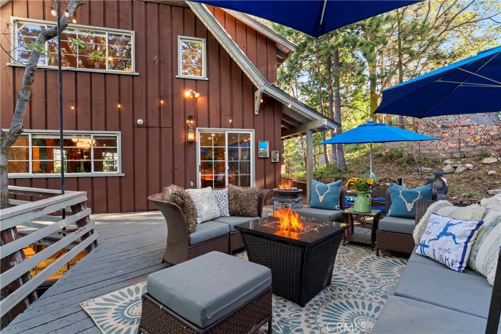 309 Castle Gate Road Lake Arrowhead, CA 92352 - Photo 50 of 58 a outdoor space with patio the couches and a umbrella