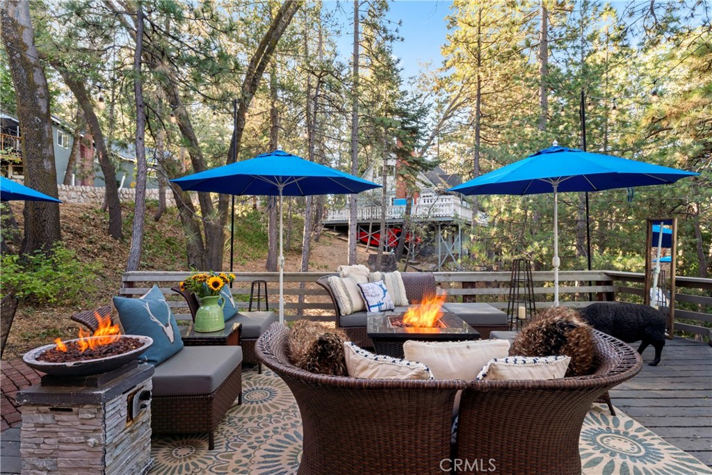 309 Castle Gate Road Lake Arrowhead, CA 92352 - Photo 51 of 58 a view of a patio with couches under an umbrella