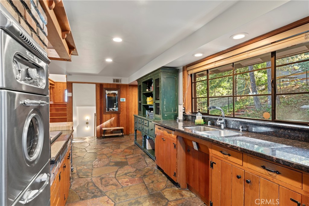 309 Castle Gate Road Lake Arrowhead, CA 92352 - Photo 9 of 58 a large kitchen with stainless steel appliances granite countertop a sink and cabinets