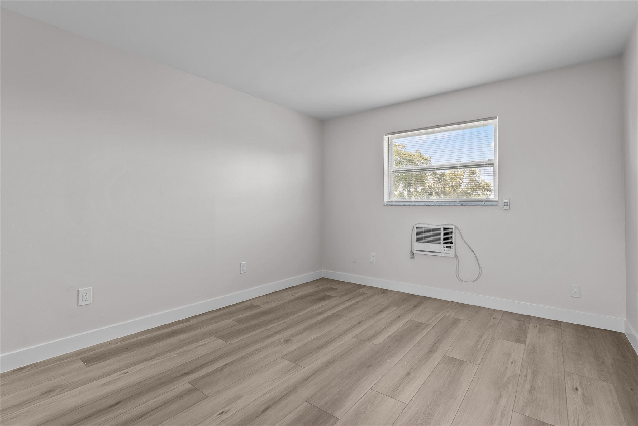 1150 East Sample Road, Unit 202 Pompano Beach, FL 33064 - Photo 13 of 20 an empty room with a workbench
