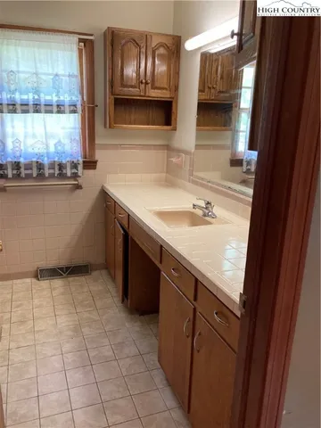 a kitchen with a sink and cabinets