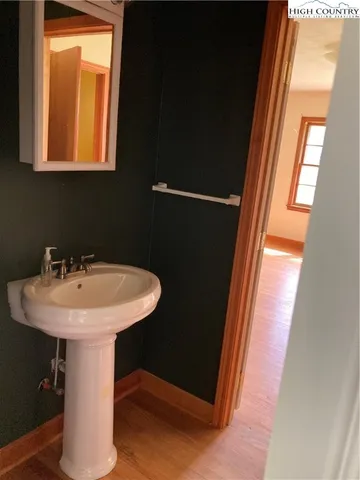 a bathroom with a sink a mirror and window