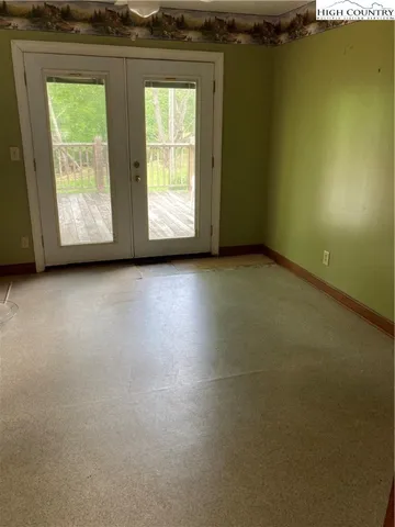 a view of a livingroom with an empty space and a window