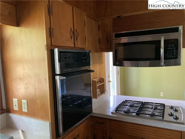 a kitchen with a stove and a microwave