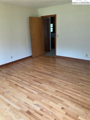 a view of a room with wooden floor