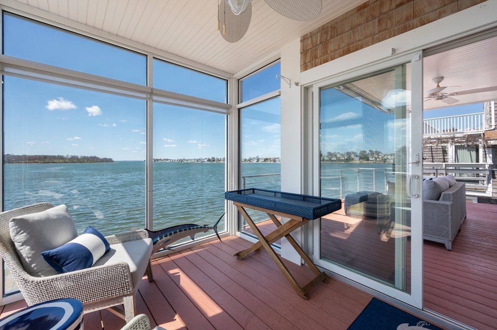 87 Bay Street Hull, MA 02045 - Photo 11 of 30 a living room with furniture and a floor to ceiling window