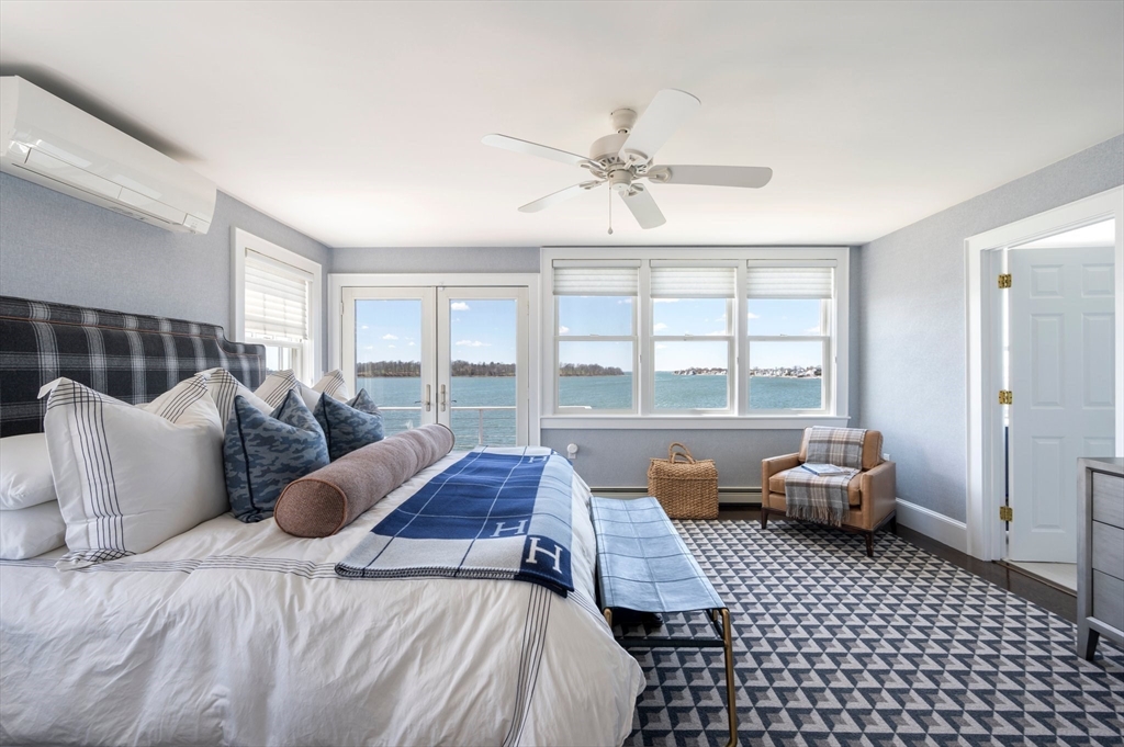 87 Bay Street Hull, MA 02045 - Photo 13 of 30 a bedroom with a bed and glass window