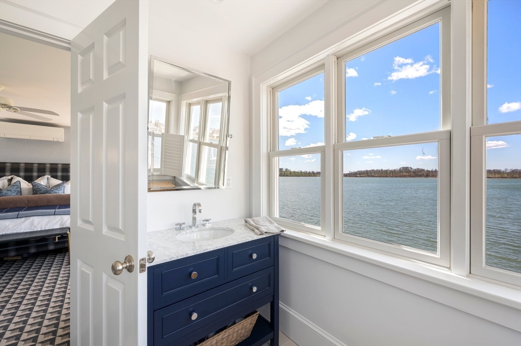 87 Bay Street Hull, MA 02045 - Photo 16 of 30 a bathroom with a tub a sink and a large window