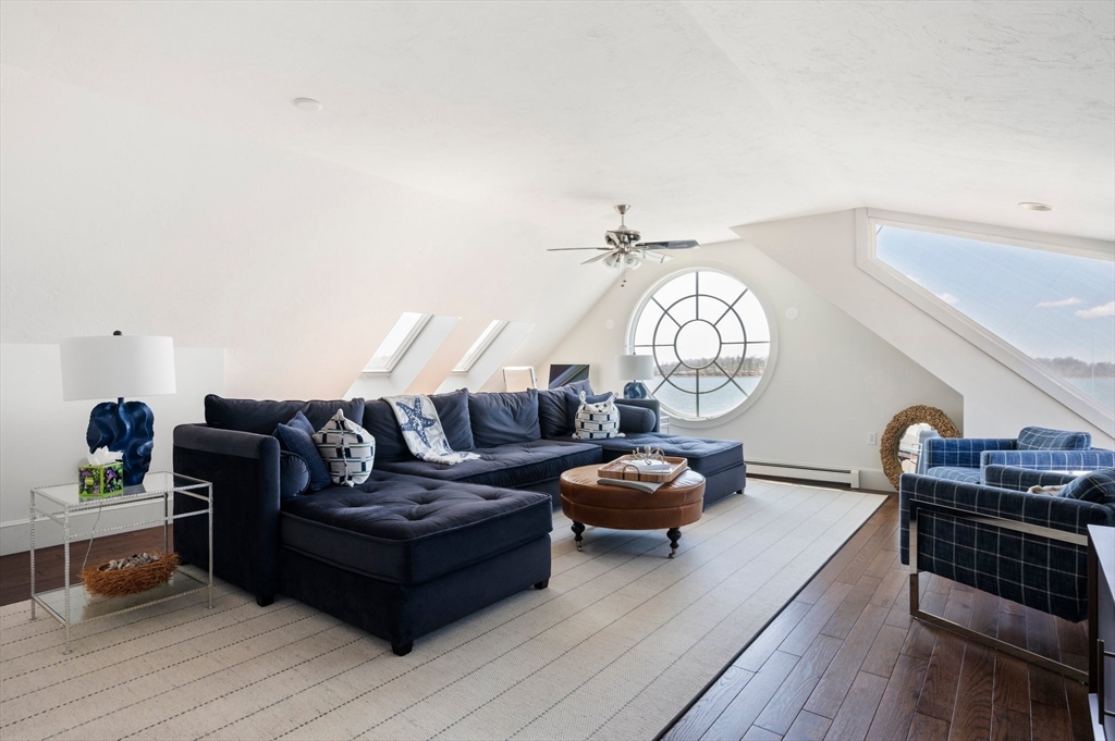 87 Bay Street Hull, MA 02045 - Photo 18 of 30 a living room with furniture a rug and a chandelier