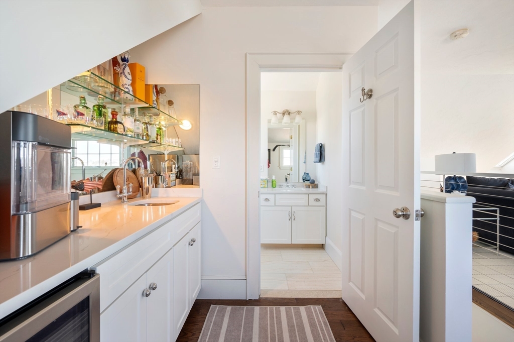 87 Bay Street Hull, MA 02045 - Photo 20 of 30 a bathroom with a sink and mirror with shower