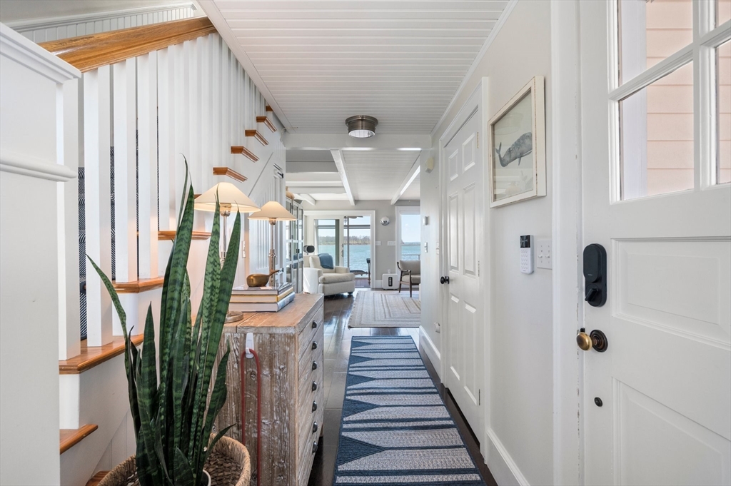 87 Bay Street Hull, MA 02045 - Photo 4 of 30 a view of a hallway with windows and stairs