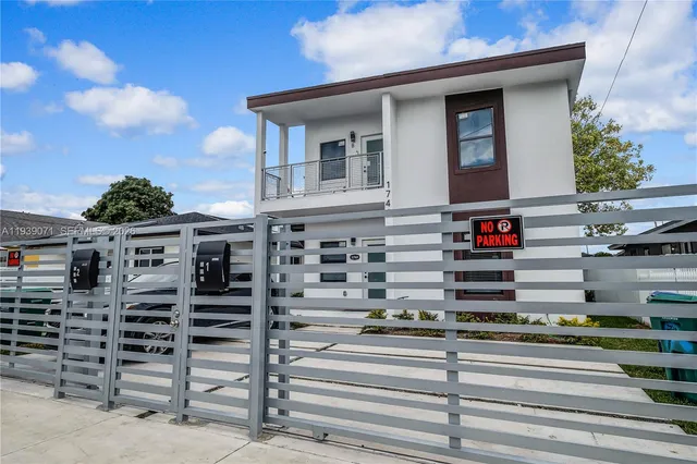 a view of a building with car parked