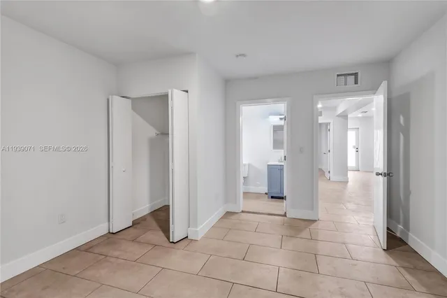 a view of a hallway to rooms