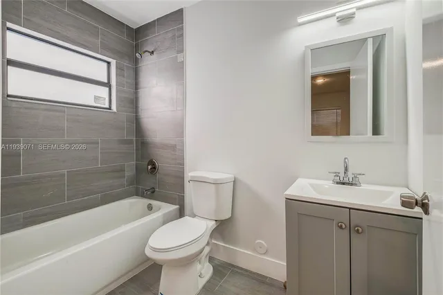a bathroom with a shower a sink and toilet