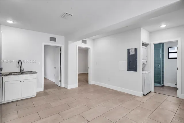a view of a kitchen with a sink and a refrigerator