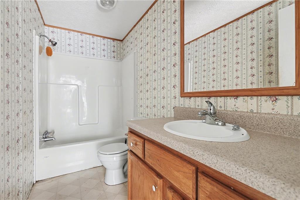 249 John Golden Road Temple, GA 30179 - Photo 37 of 45 a bathroom with a sink a toilet and shower curtain