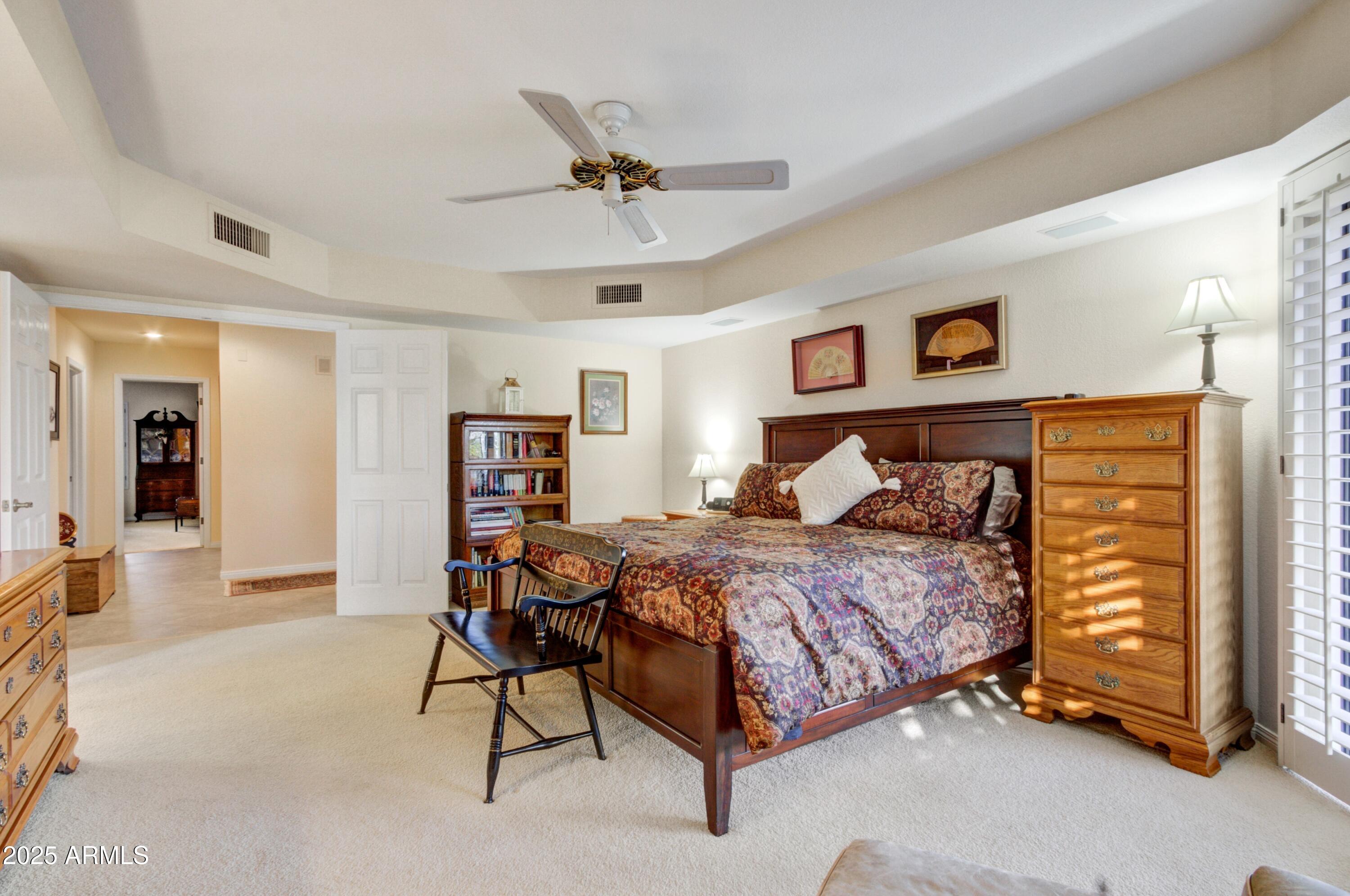 18919 East Reata Drive Rio Verde, AZ 85263 - Photo 14 of 35 a bedroom with a bed and a chandelier