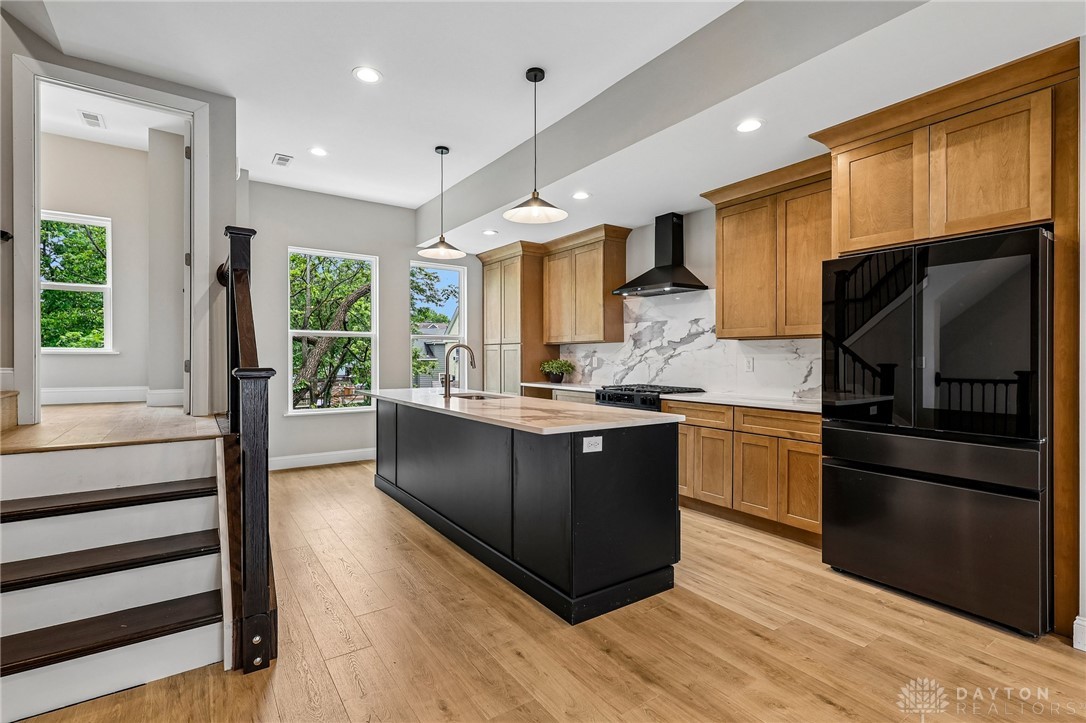 3906 Edwards Road, Unit C Cincinnati, OH 45209 - Photo 11 of 46 This modern kitchen features a spacious island and gleaming hardwood floors, perfect for entertaining.