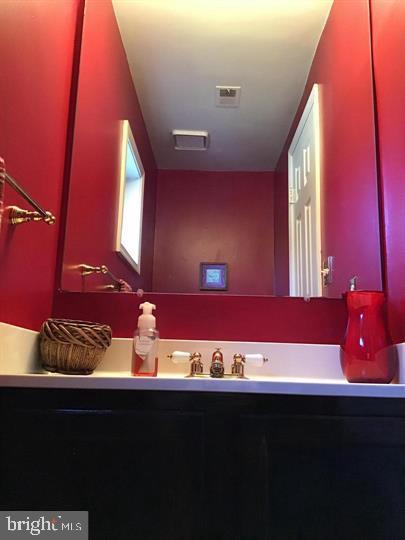 9301 Palmer Place, Unit 40 Laurel, MD 20708 - Photo 3 of 12 Vibrant red walls enhance this chic bathroom.