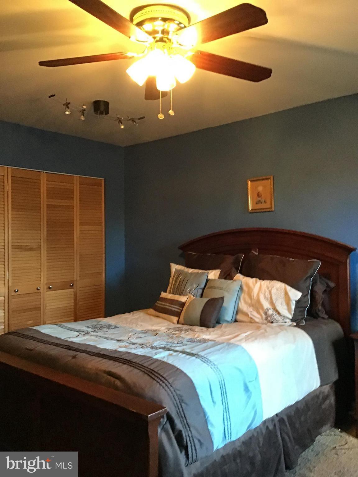 9301 Palmer Place, Unit 40 Laurel, MD 20708 - Photo 9 of 12 Cozy bedroom with calming blue hues.