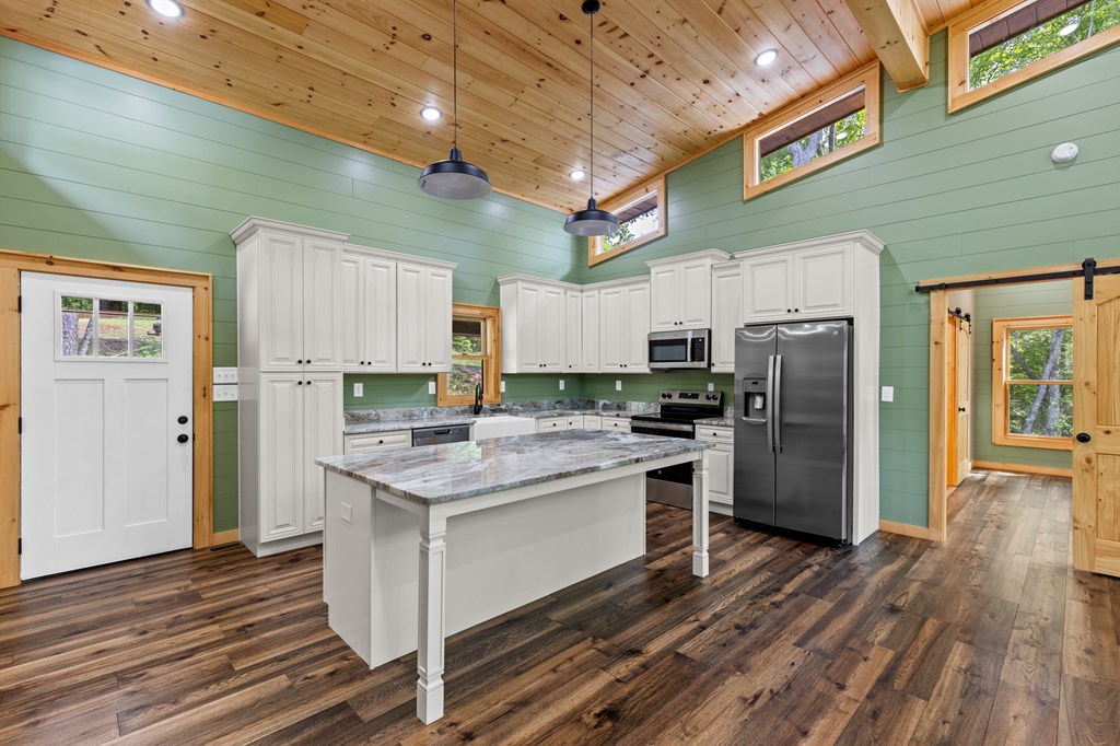 307 Mangum's Trail Blue Ridge, GA 30513 - Photo 11 of 36 a kitchen with a refrigerator and a stove