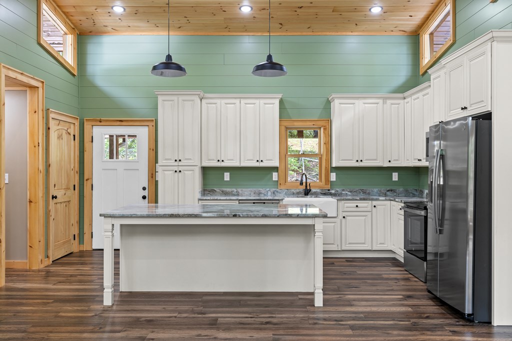 307 Mangum's Trail Blue Ridge, GA 30513 - Photo 12 of 36 a kitchen with stainless steel appliances granite countertop a sink a stove and a refrigerator
