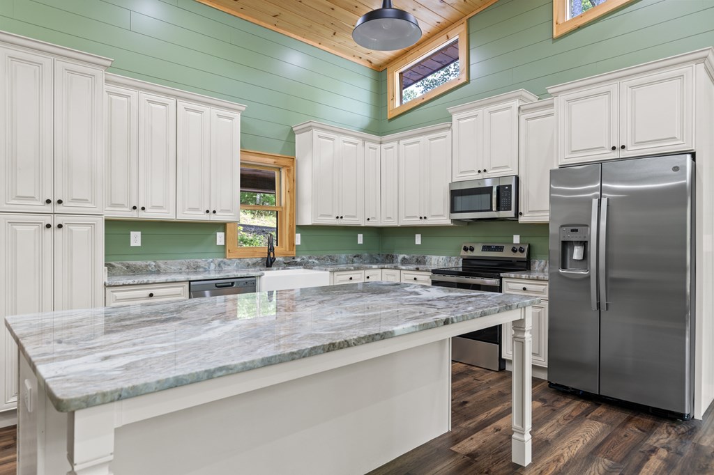 307 Mangum's Trail Blue Ridge, GA 30513 - Photo 13 of 36 a kitchen with stainless steel appliances granite countertop a stove a sink and a refrigerator