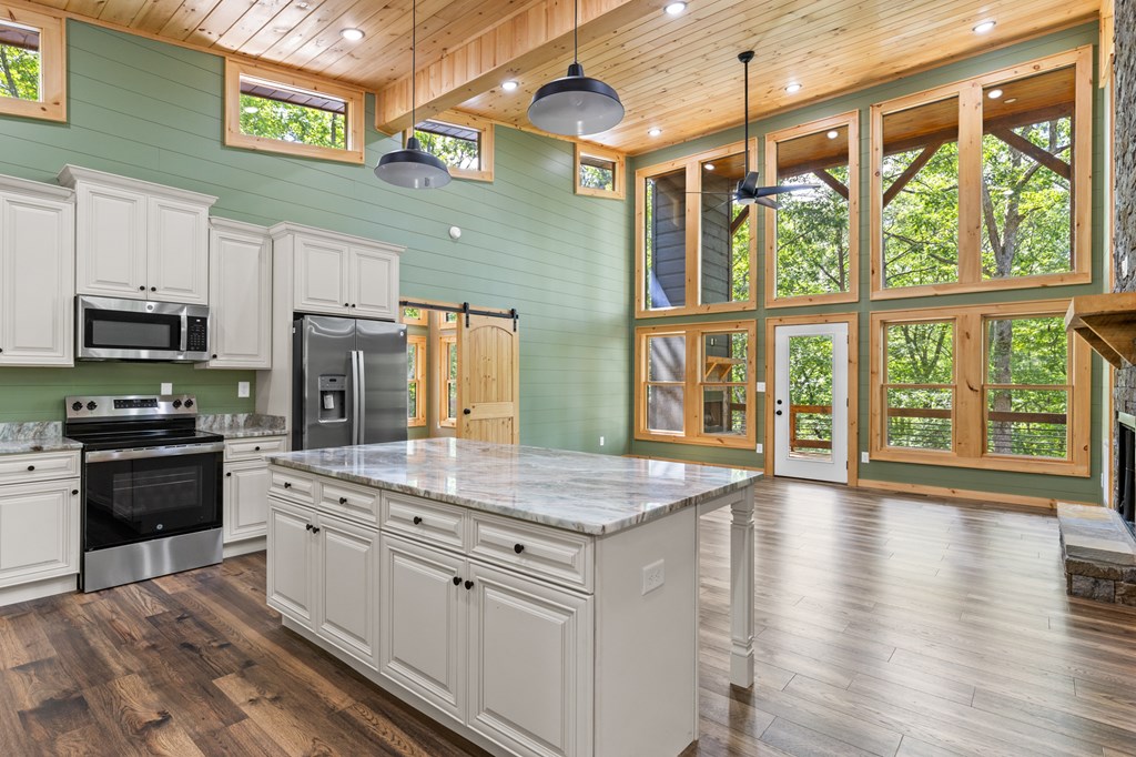 307 Mangum's Trail Blue Ridge, GA 30513 - Photo 15 of 36 a kitchen with stainless steel appliances granite countertop a stove a sink and a refrigerator