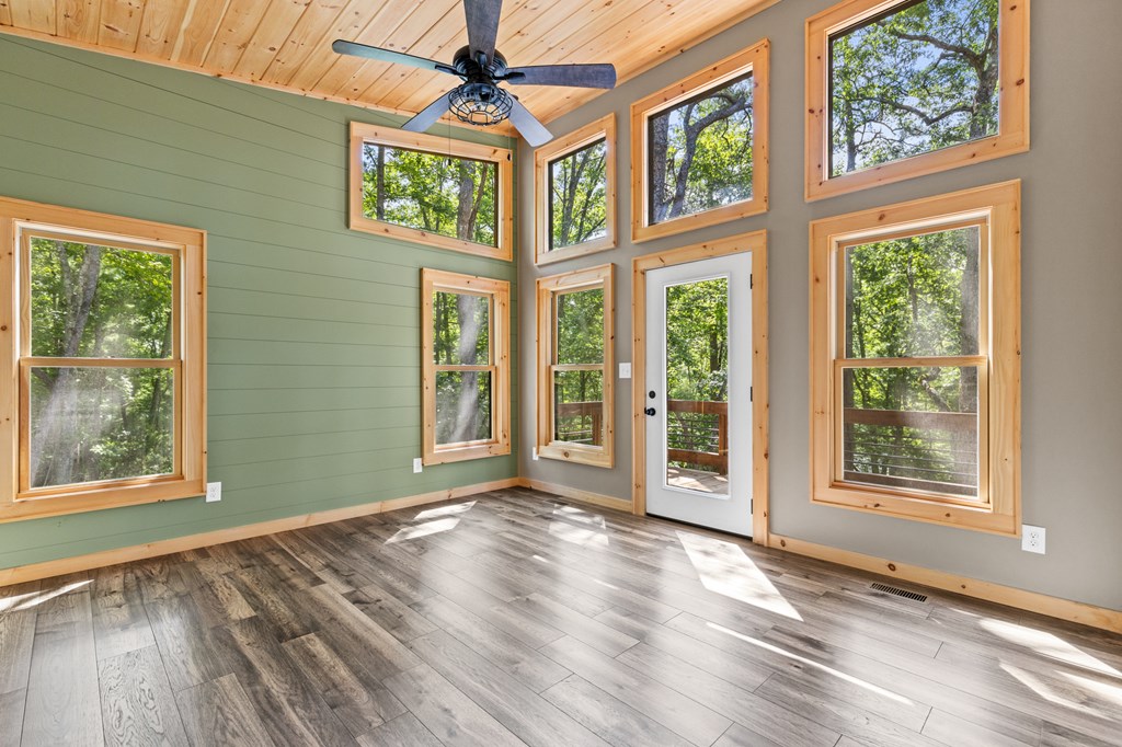 307 Mangum's Trail Blue Ridge, GA 30513 - Photo 19 of 36 a view of an empty room with a window and wooden floor
