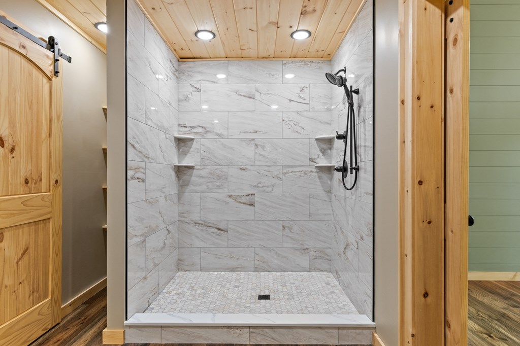 307 Mangum's Trail Blue Ridge, GA 30513 - Photo 24 of 36 a bathroom with a glass shower door