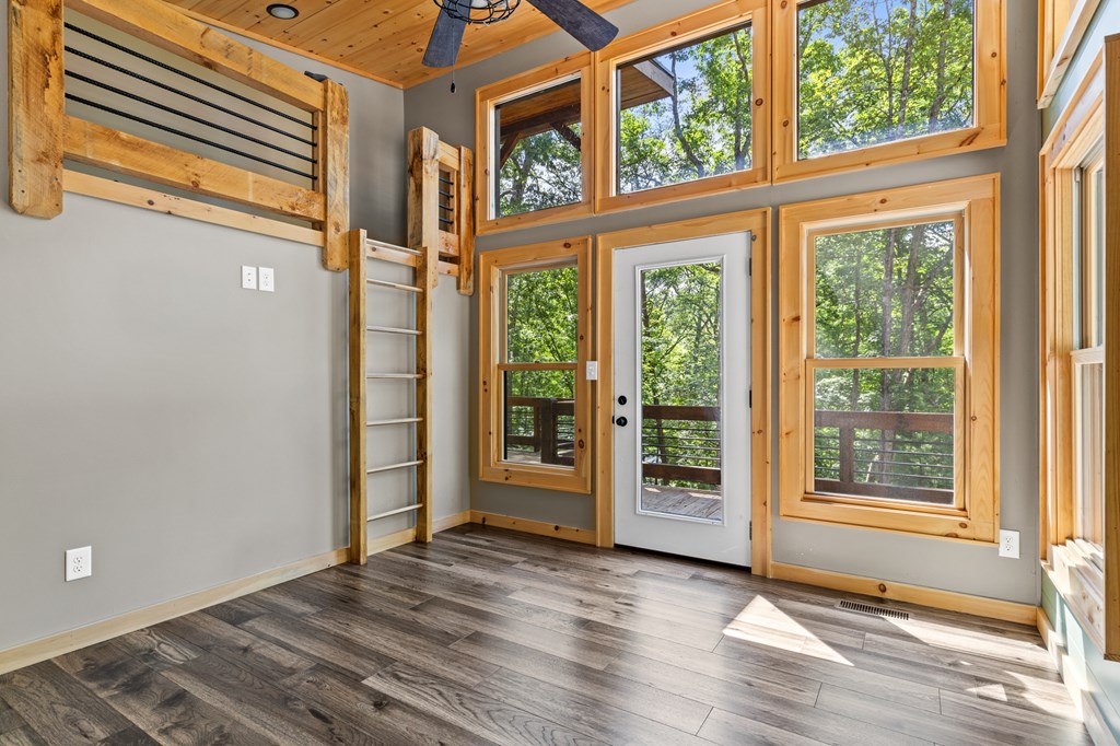 307 Mangum's Trail Blue Ridge, GA 30513 - Photo 27 of 36 an empty room with wooden floor and windows