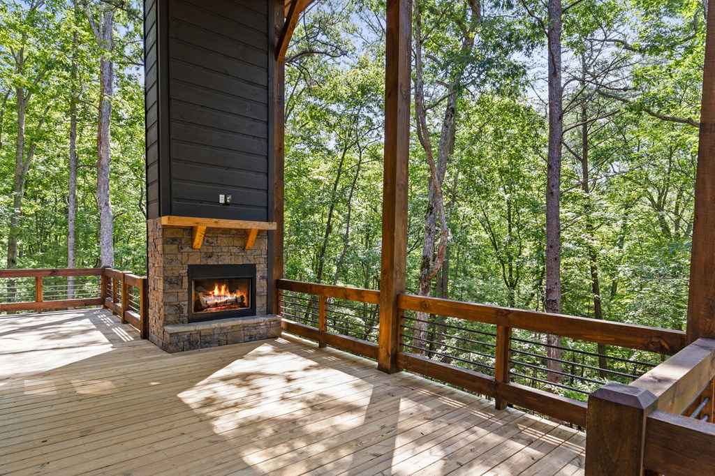 307 Mangum's Trail Blue Ridge, GA 30513 - Photo 6 of 36 a living room with a fireplace and a floor to ceiling window