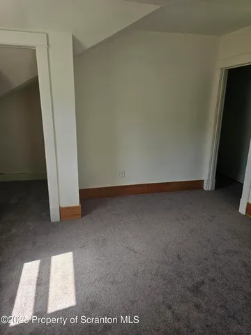 an empty room with a empty space and windows