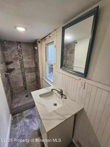 a bathroom with a sink a toilet and mirror