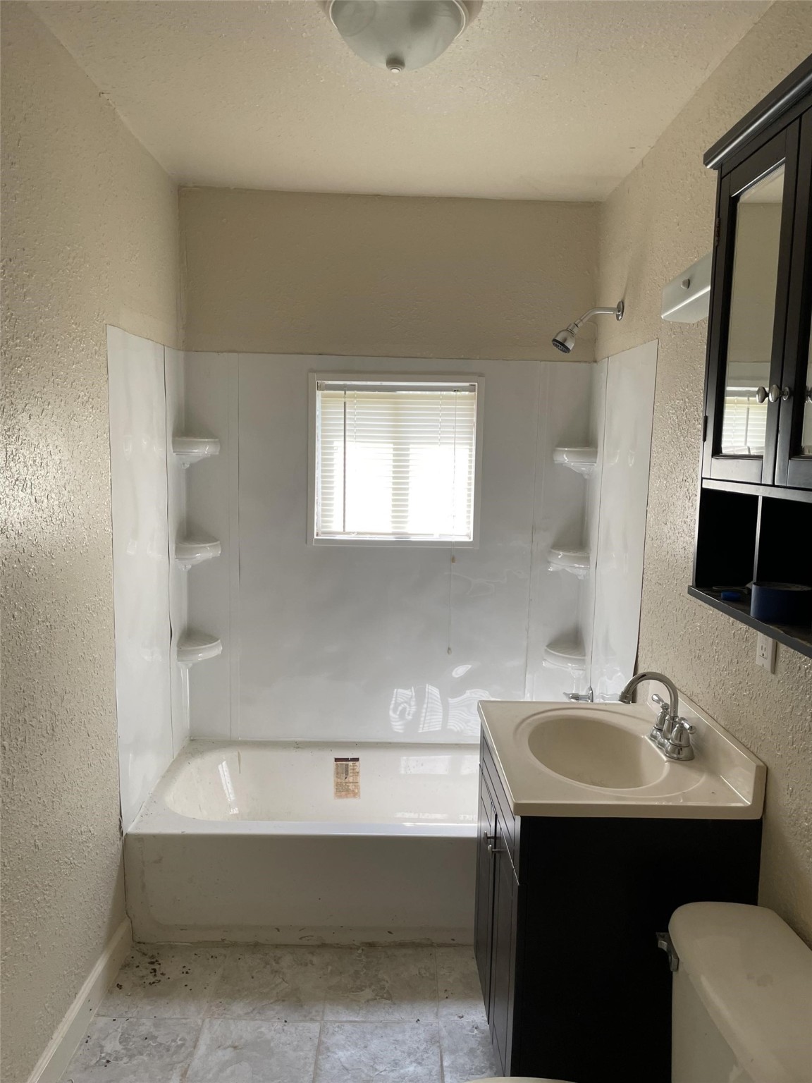 301 Connecticut Street Houston, TX 77029 - Photo 2 of 24 a bathroom with a sink a bathtub and a mirror
