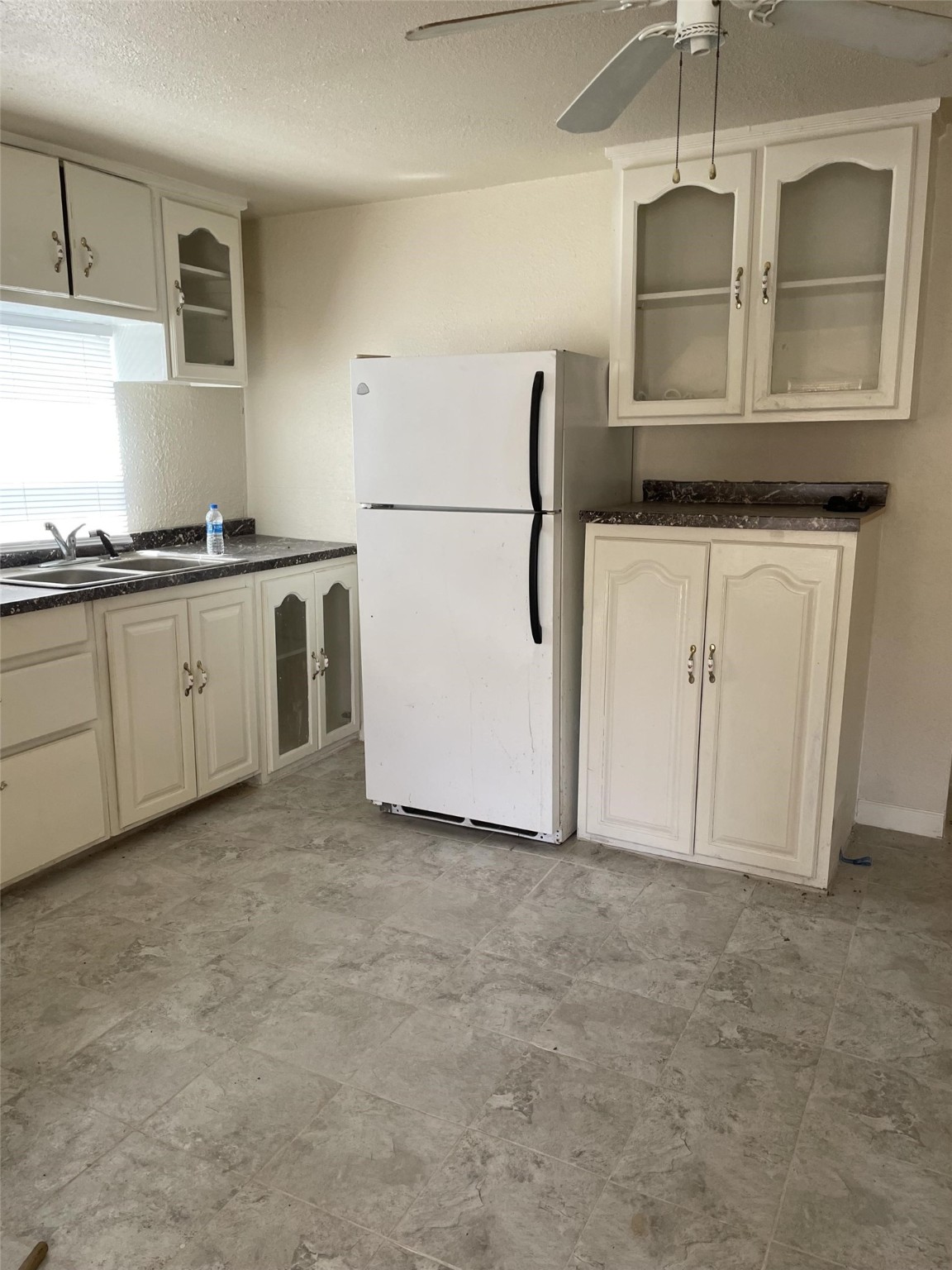 301 Connecticut Street Houston, TX 77029 - Photo 22 of 24 a kitchen with granite countertop white cabinets and refrigerator