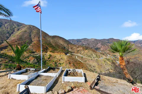 a view of a terrace with couches and sky view