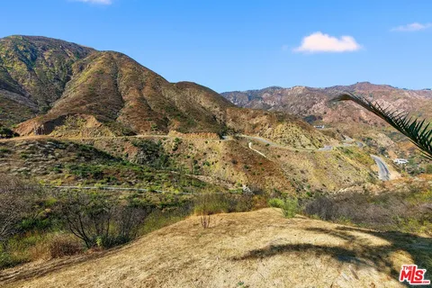 a view of a houses with mountains in the background