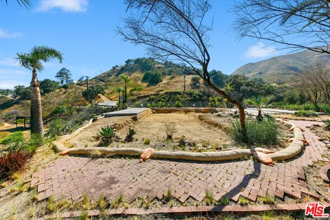 a view of a backyard with wooden fence