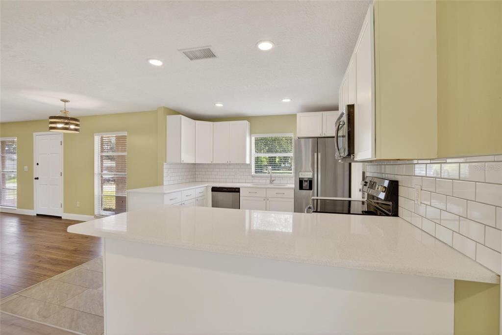 2340 Merrily Circle South Seffner, FL 33584 - Photo 15 of 52 a large kitchen with cabinets and wooden floor