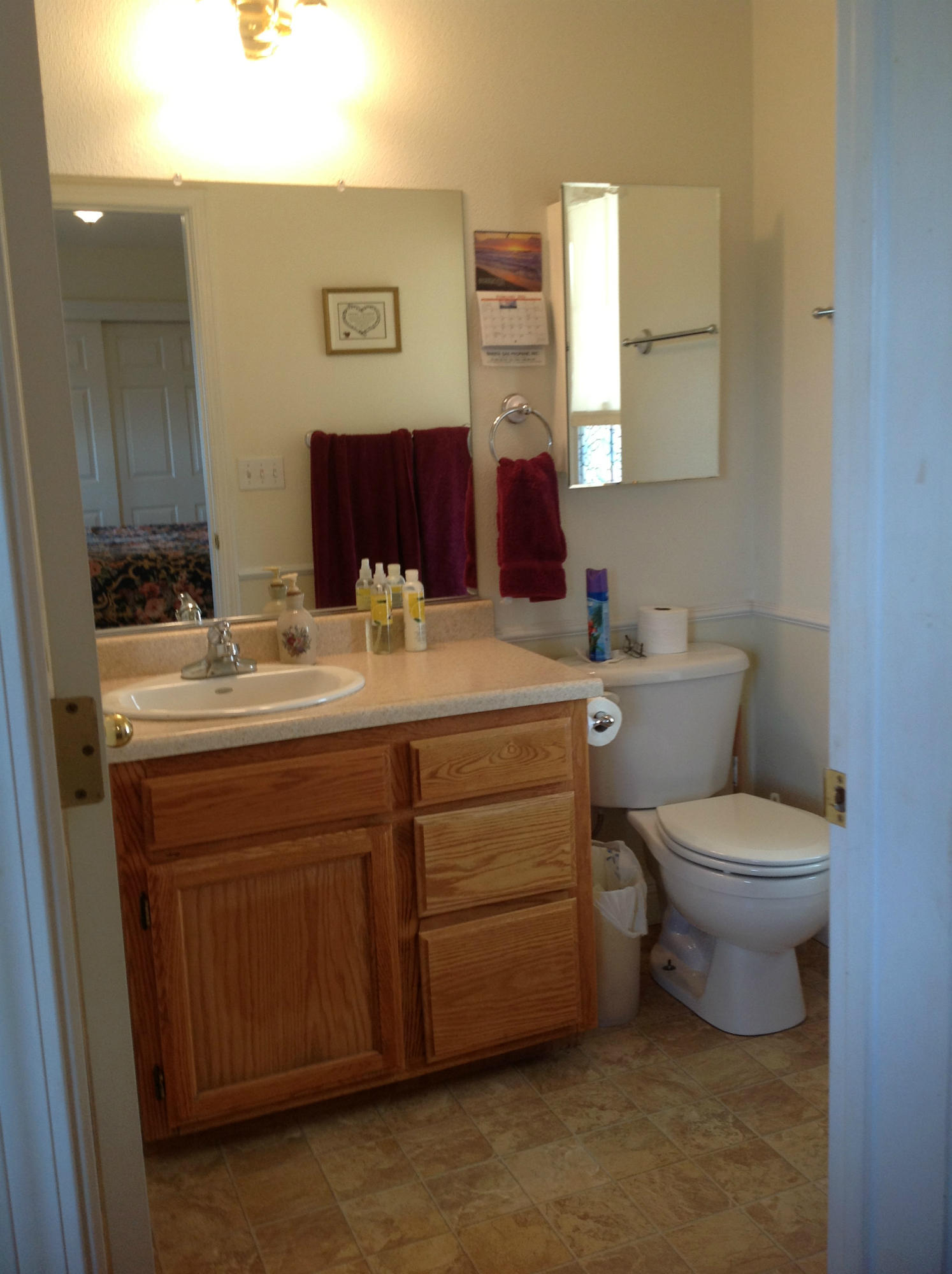 29204 Park Road Bella Vista, CA 96008 - Photo 10 of 41 a bathroom with a toilet sink vanity and mirror