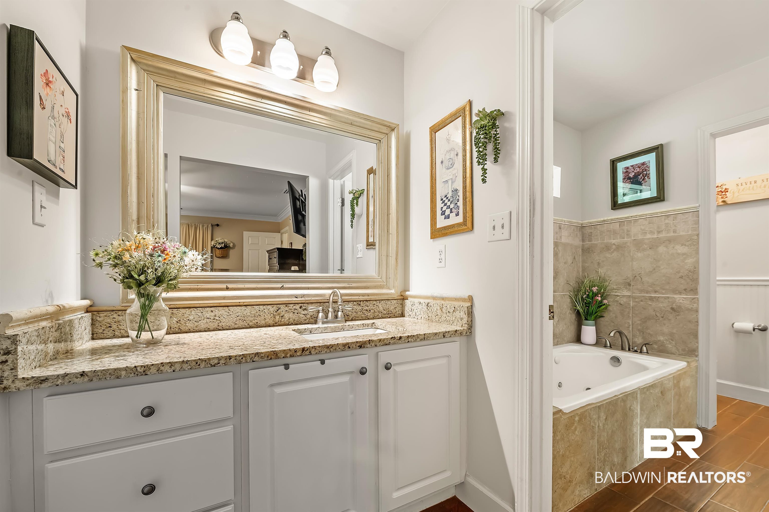 9901 Glover Court Fairhope, AL 36532 - Photo 20 of 52 Bathroom with tiled tub, vanity, and crown molding