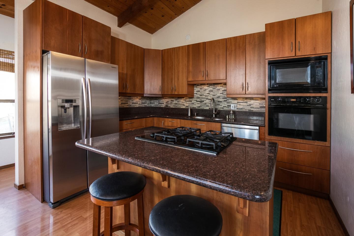 6113 Abbey Road Aptos, CA 95003 - Photo 1 of 20 a kitchen with granite countertop a stove and a refrigerator