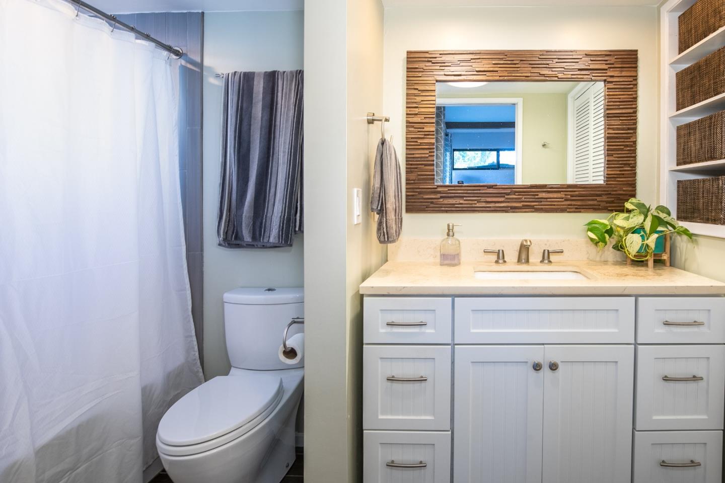 6113 Abbey Road Aptos, CA 95003 - Photo 13 of 20 a bathroom with a toilet sink vanity and mirror