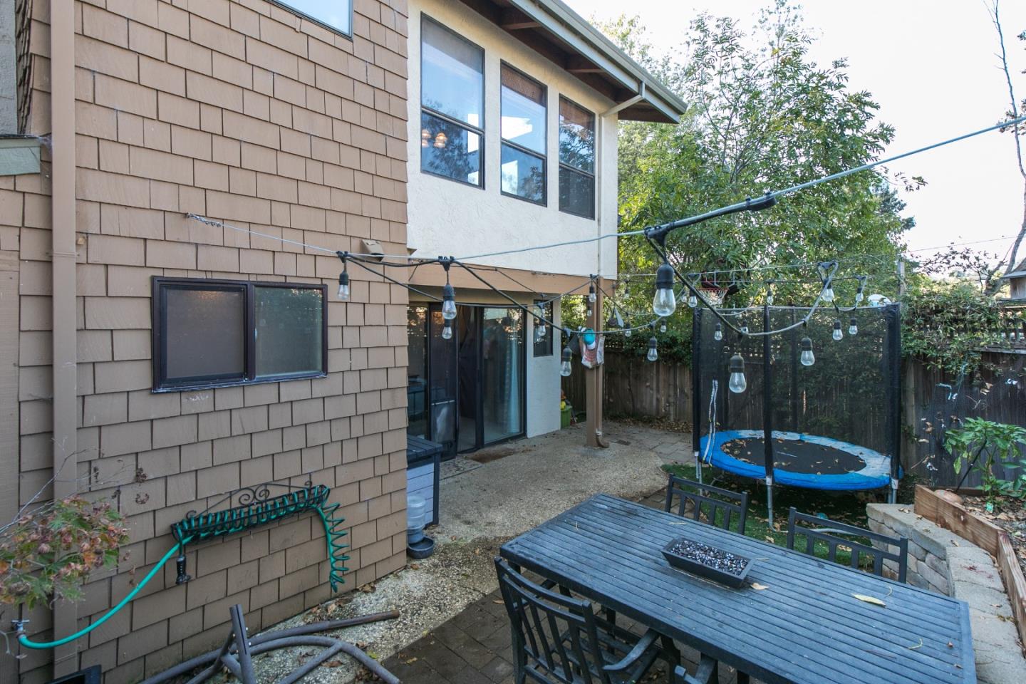 6113 Abbey Road Aptos, CA 95003 - Photo 16 of 20 a backyard of a house with barbeque oven table and chairs