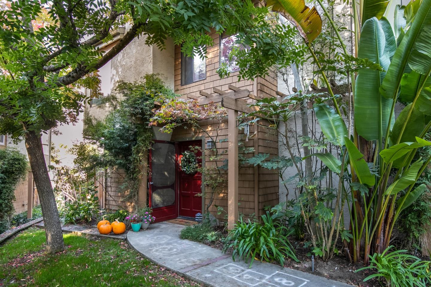 6113 Abbey Road Aptos, CA 95003 - Photo 2 of 20 a backyard of a house with potted plants and large trees